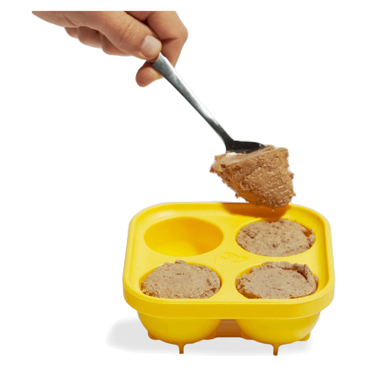 Pouring bone broth into the Woof Pupsicle Treat Tray to make DIY frozen dog treats